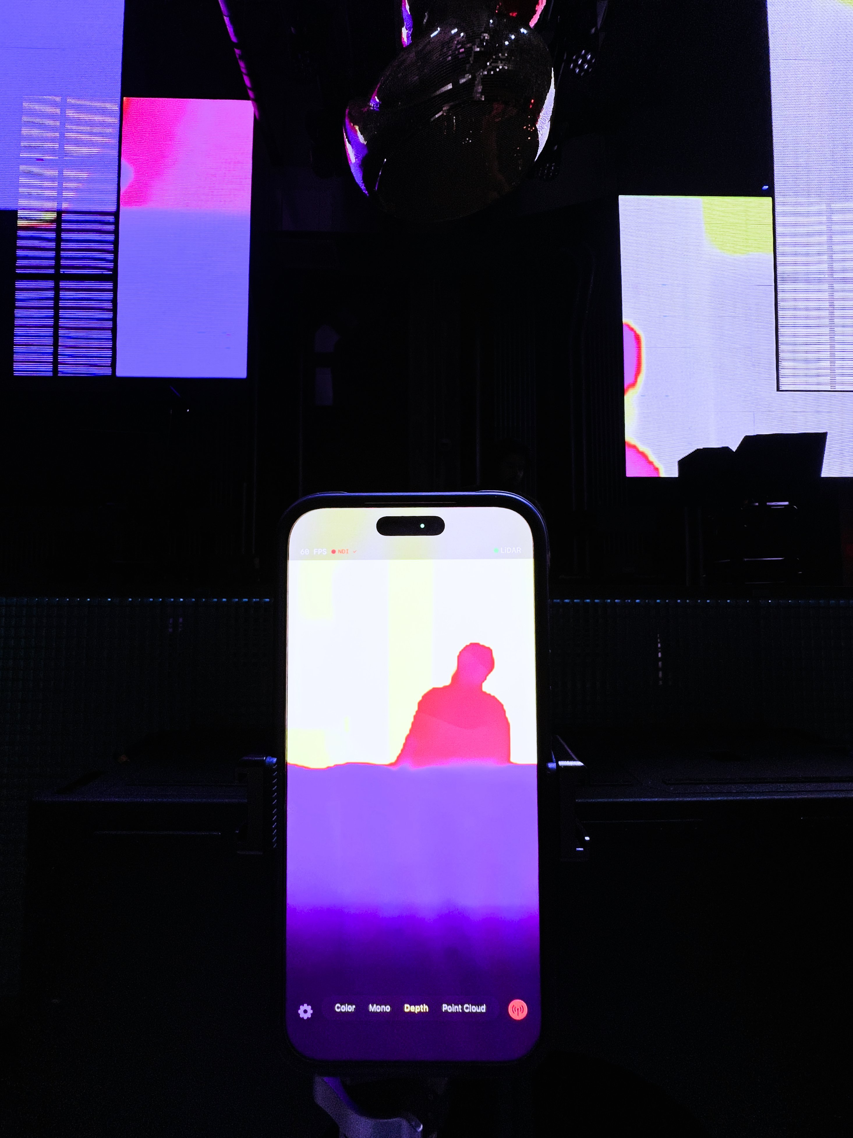 iPhone running LOTA in depth mode at a live event with LED screens